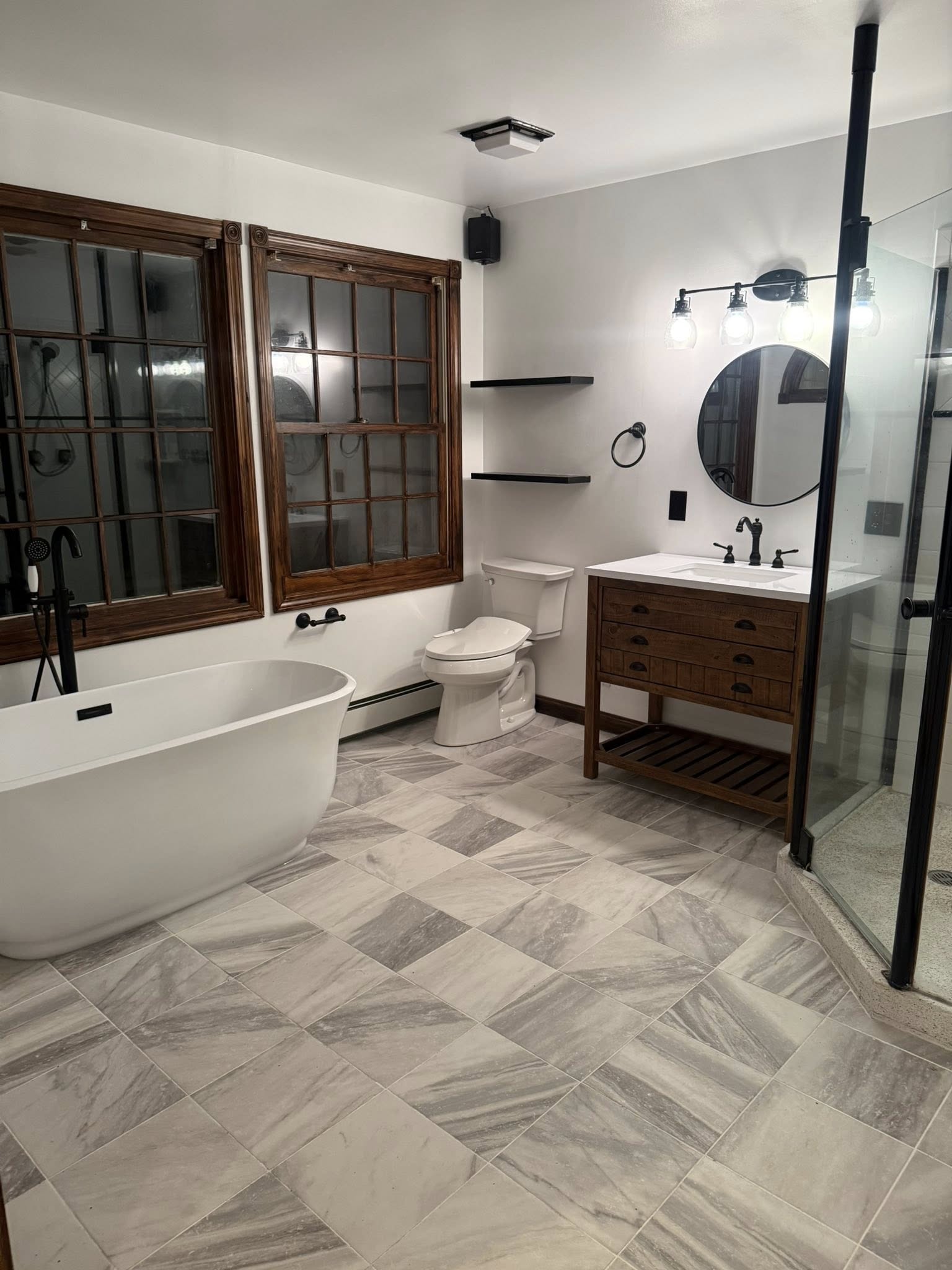 Completed luxury bathroom remodel — freestanding tub, marble tile