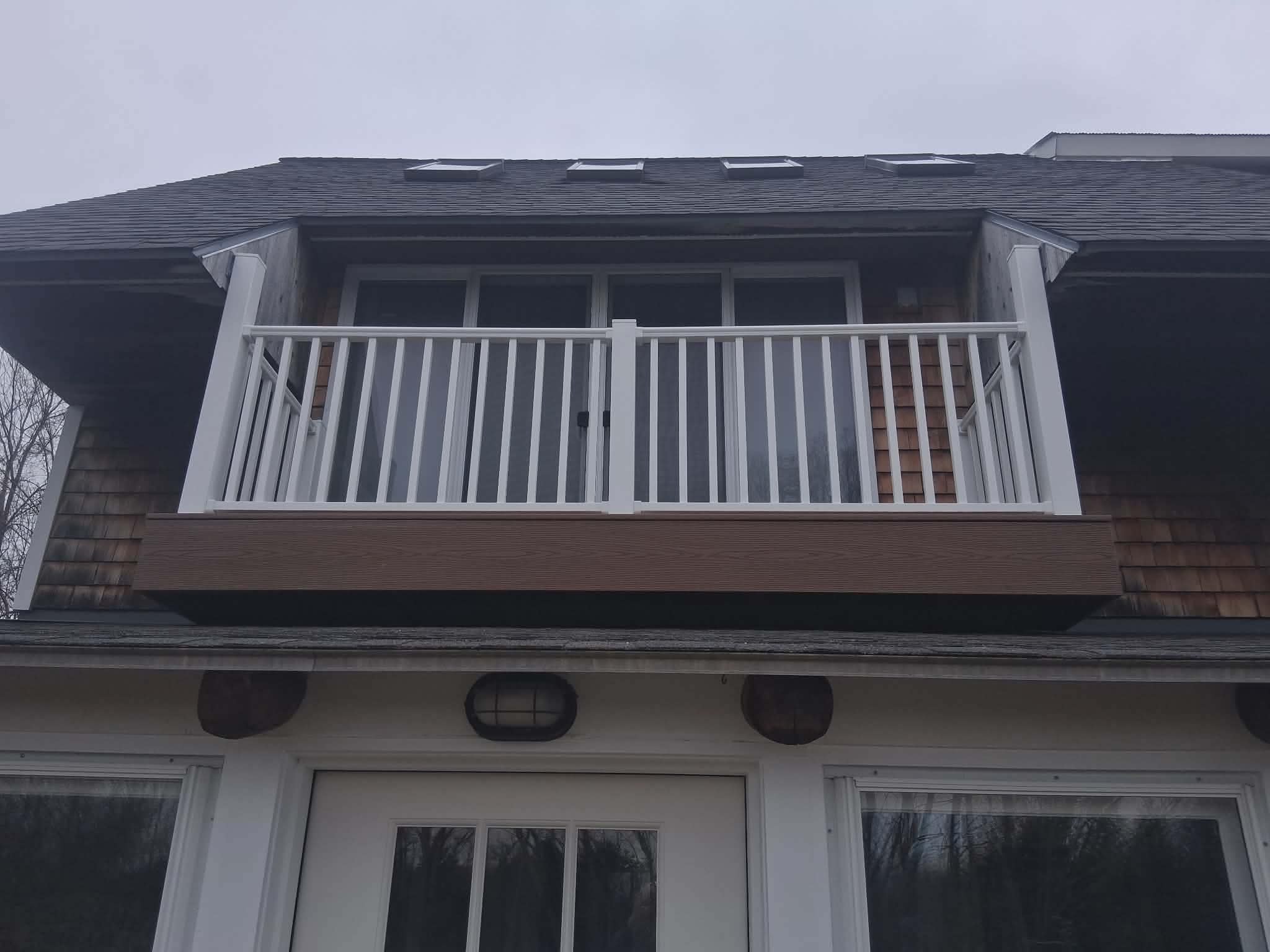 Completed rooftop deck with white vinyl railing — front view