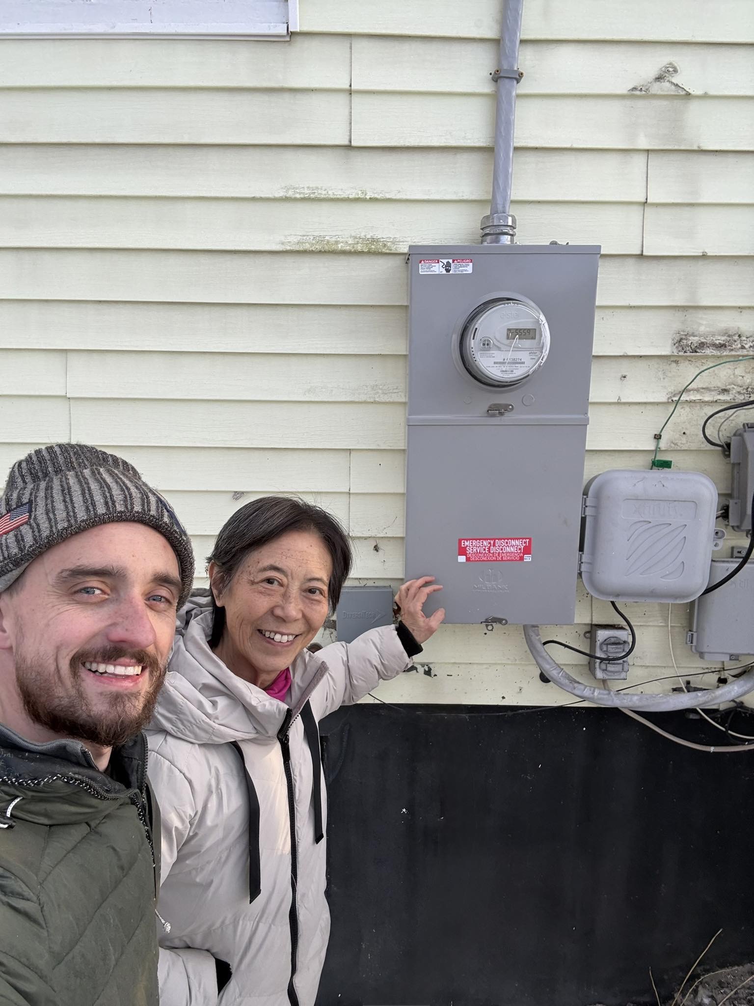VTGC tech and happy homeowner with completed panel upgrade